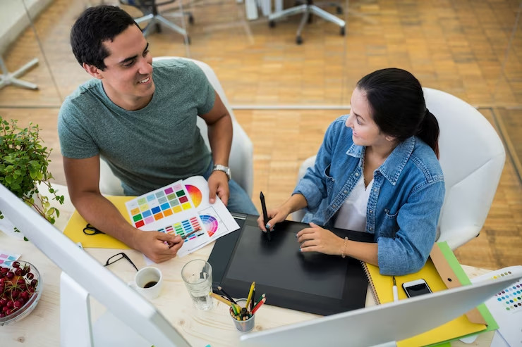 male female graphic designers interacting with each other