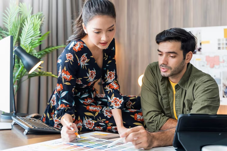 young asian caucasian adult creative partnets working with new project discussion brainstorm office day timemeeting designer partners